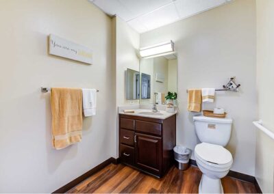 Bathroom with wooden floor and towels
