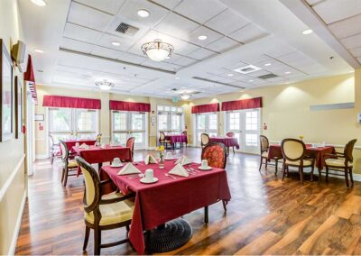 Dining room area with chandelier red table cover and chairs