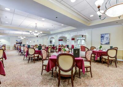 Dining room area with chandelier red table cover and chairs