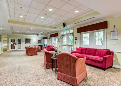 Carpeted Camarillo Hallway with red sofa and brown sofa chair